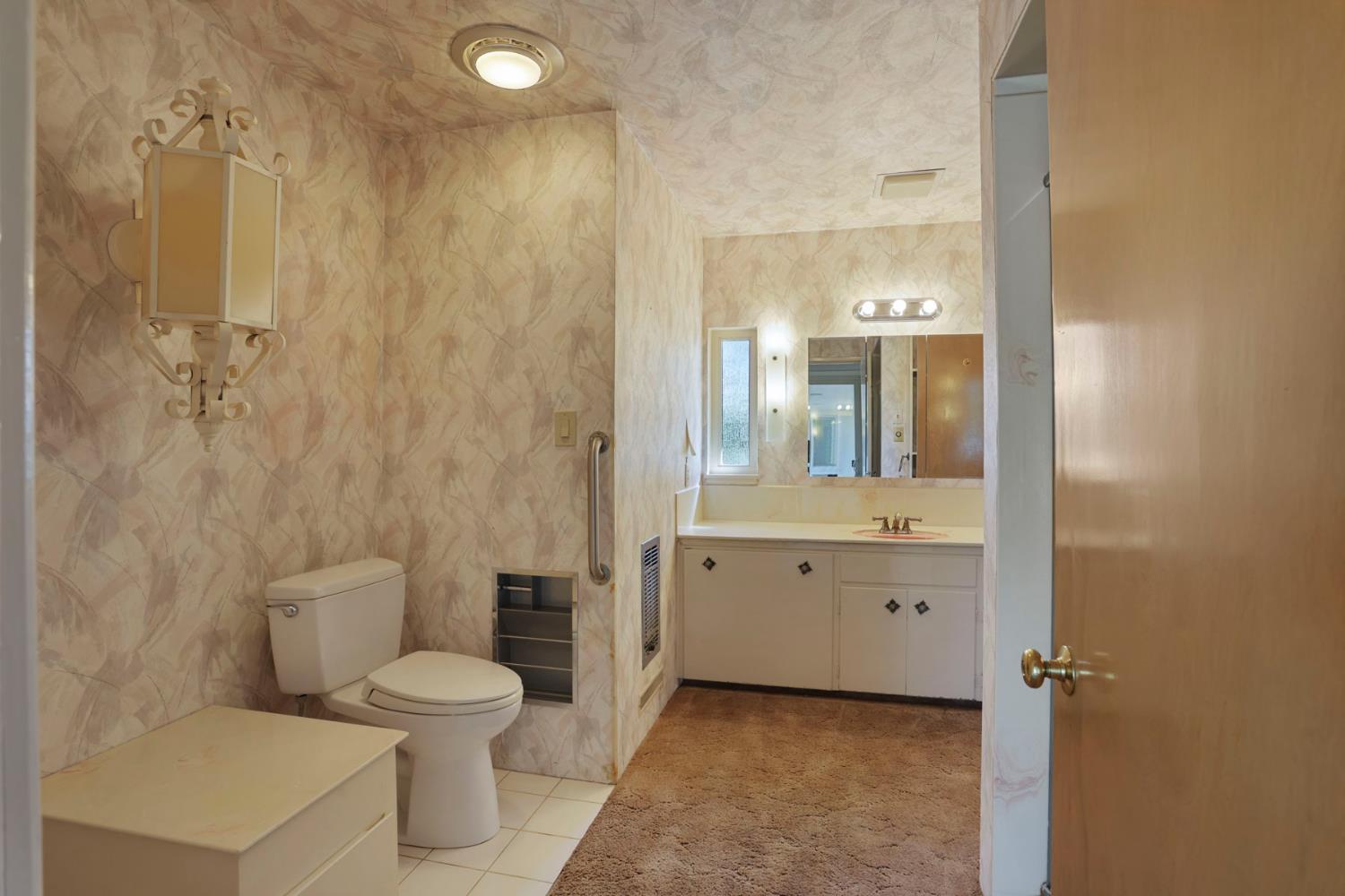 2465 Vernalis Road Tracy, CA 95304 - Photo 18 of 55 a bathroom with a granite countertop sink mirror vanity and toilet