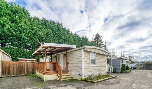 a view of backyard with deck and outdoor seating