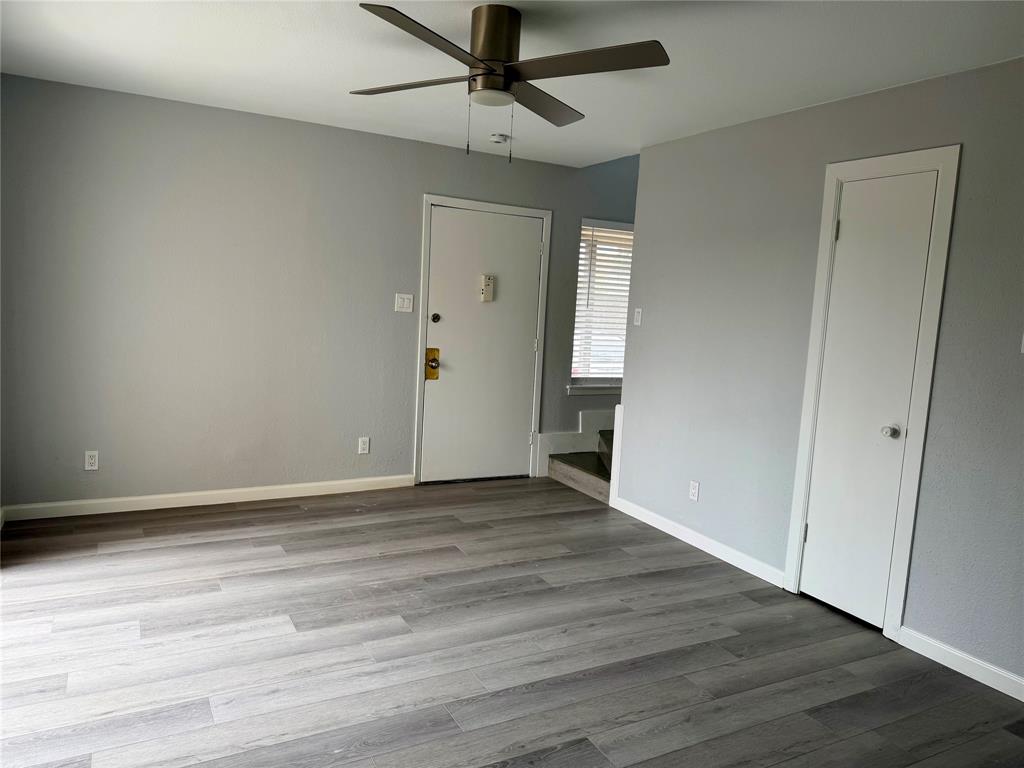 12818 Midway Road, Unit 1089 Dallas, TX 75244 - Photo 1 of 18 a view of an empty room with wooden floor
