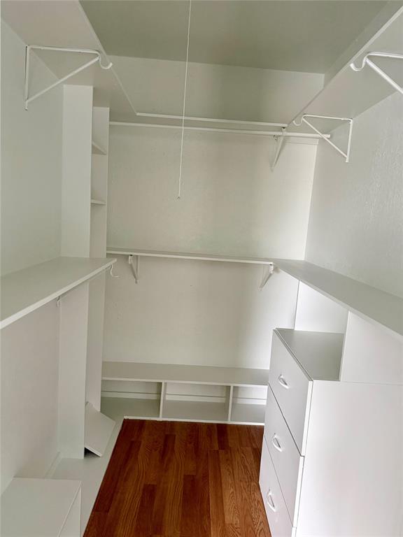 12818 Midway Road, Unit 1089 Dallas, TX 75244 - Photo 14 of 18 a view of walk in closet with empty racks
