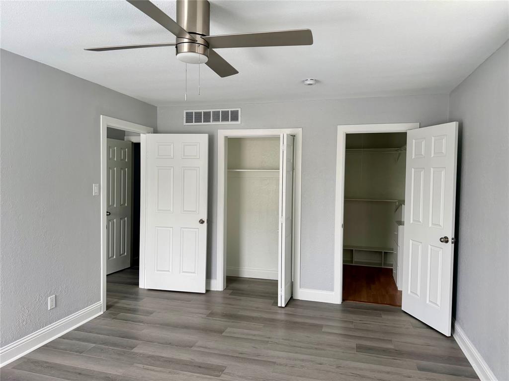 12818 Midway Road, Unit 1089 Dallas, TX 75244 - Photo 15 of 18 an empty room with wooden floor and windows