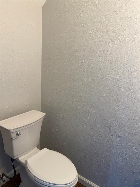 12818 Midway Road, Unit 1089 Dallas, TX 75244 - Photo 8 of 18 a white toilet sitting next to a white wall