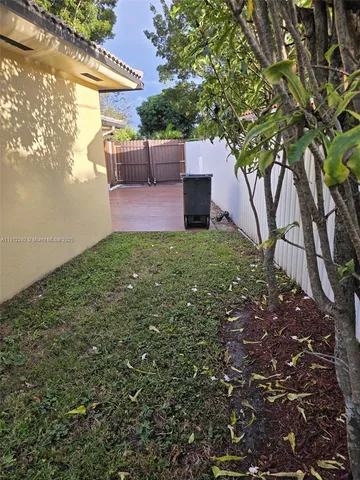 a front view of a house with a yard and table and chairs