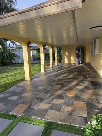 a view of a patio with table and chairs with wooden fence and plants
