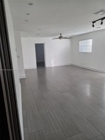 a bathroom with a granite countertop toilet and a sink