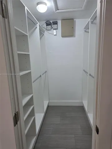 a view of a chandelier fan in an empty room