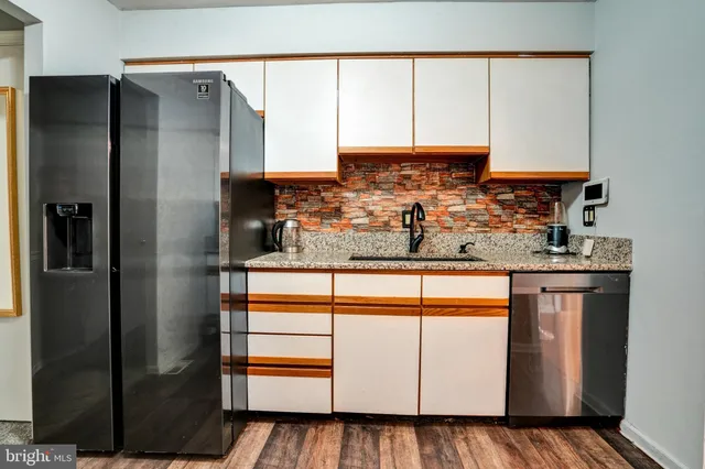 a kitchen with stainless steel appliances a refrigerator and cabinets