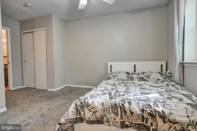 a bedroom with a bed and a mirror