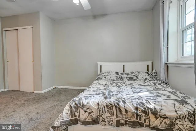 a bedroom with a bed and window