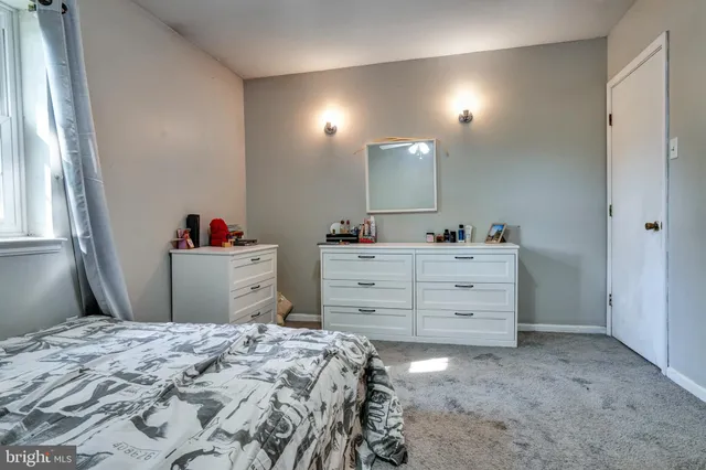 a bed room with a bed and a mirror