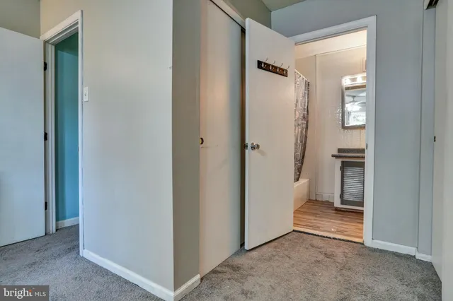 a view of a hallway with an empty room and a hallway