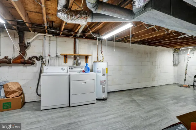 a utility room with cabinets dryer and washer