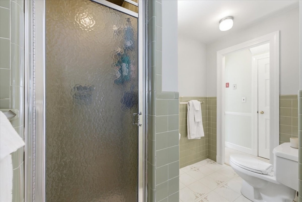 46 Park Street Dedham, MA 02026 - Photo 15 of 35 a bathroom with a shower and toilet