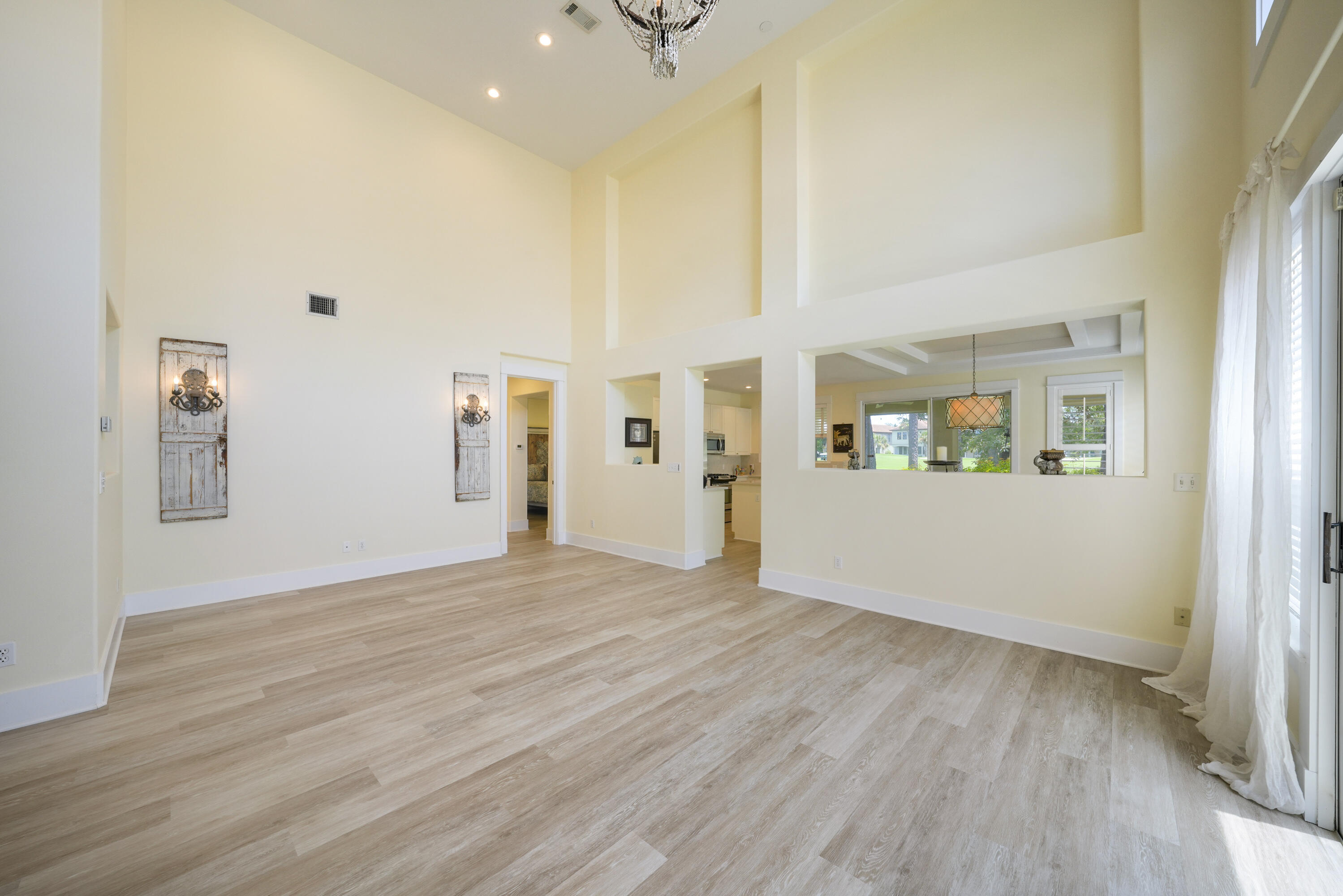 8026 Legend Creek Dr. Miramar Beach, FL 32550 - Photo 10 of 88 a view of an empty room with wooden floor and a window