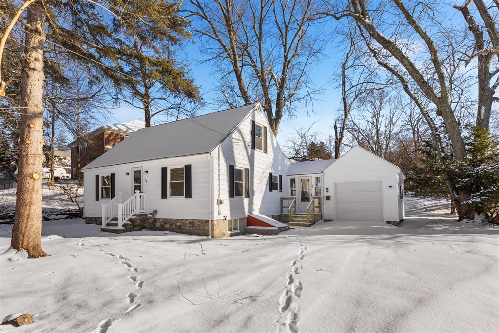 a view of a house with a snow in front of yard