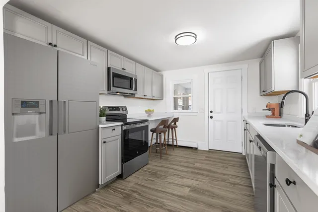 a kitchen with a refrigerator stove and sink