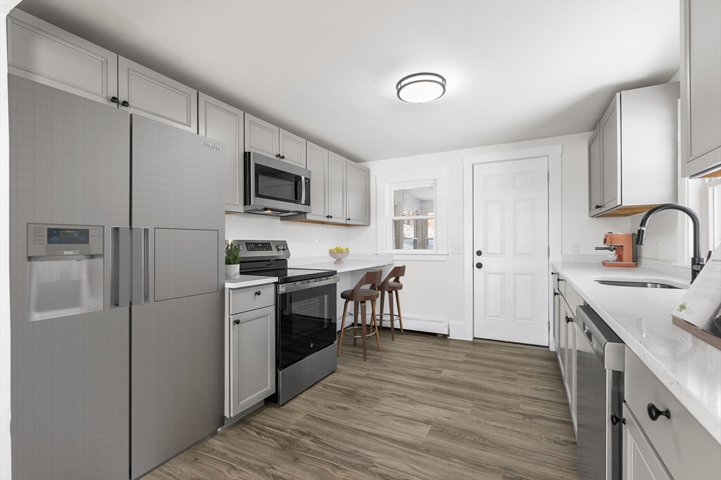 26 River Street Billerica, MA 01821 - Photo 4 of 10 a kitchen with a refrigerator stove and sink