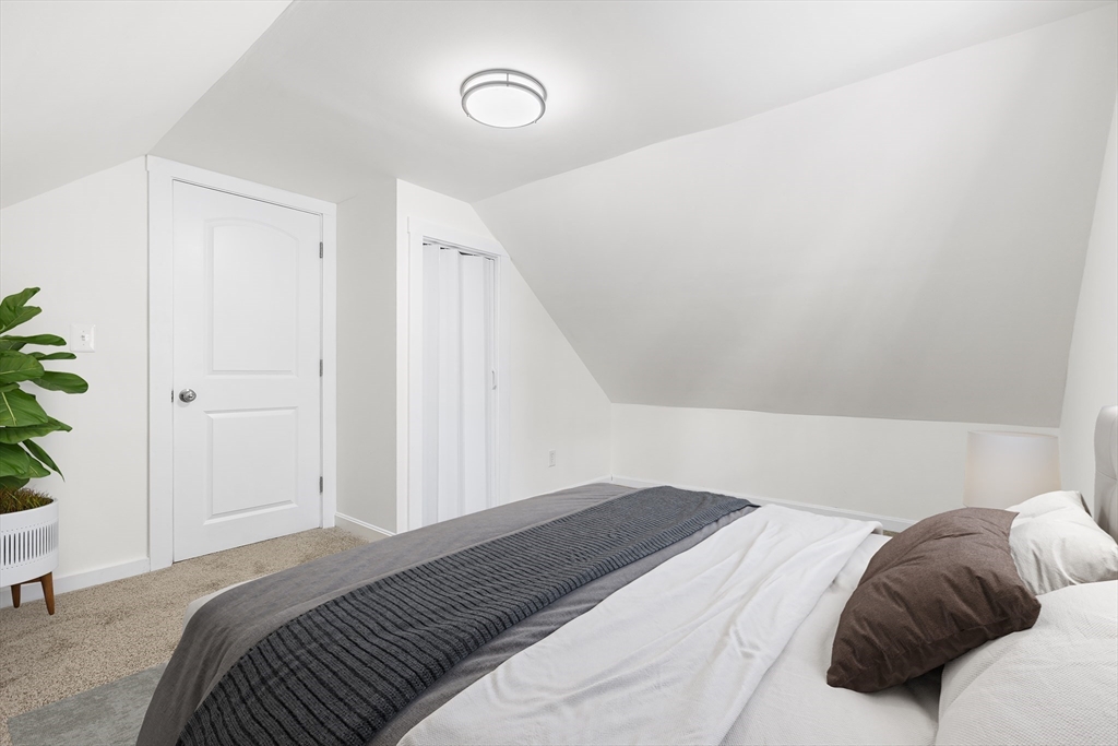 26 River Street Billerica, MA 01821 - Photo 8 of 10 a bedroom with a bed and a potted plant