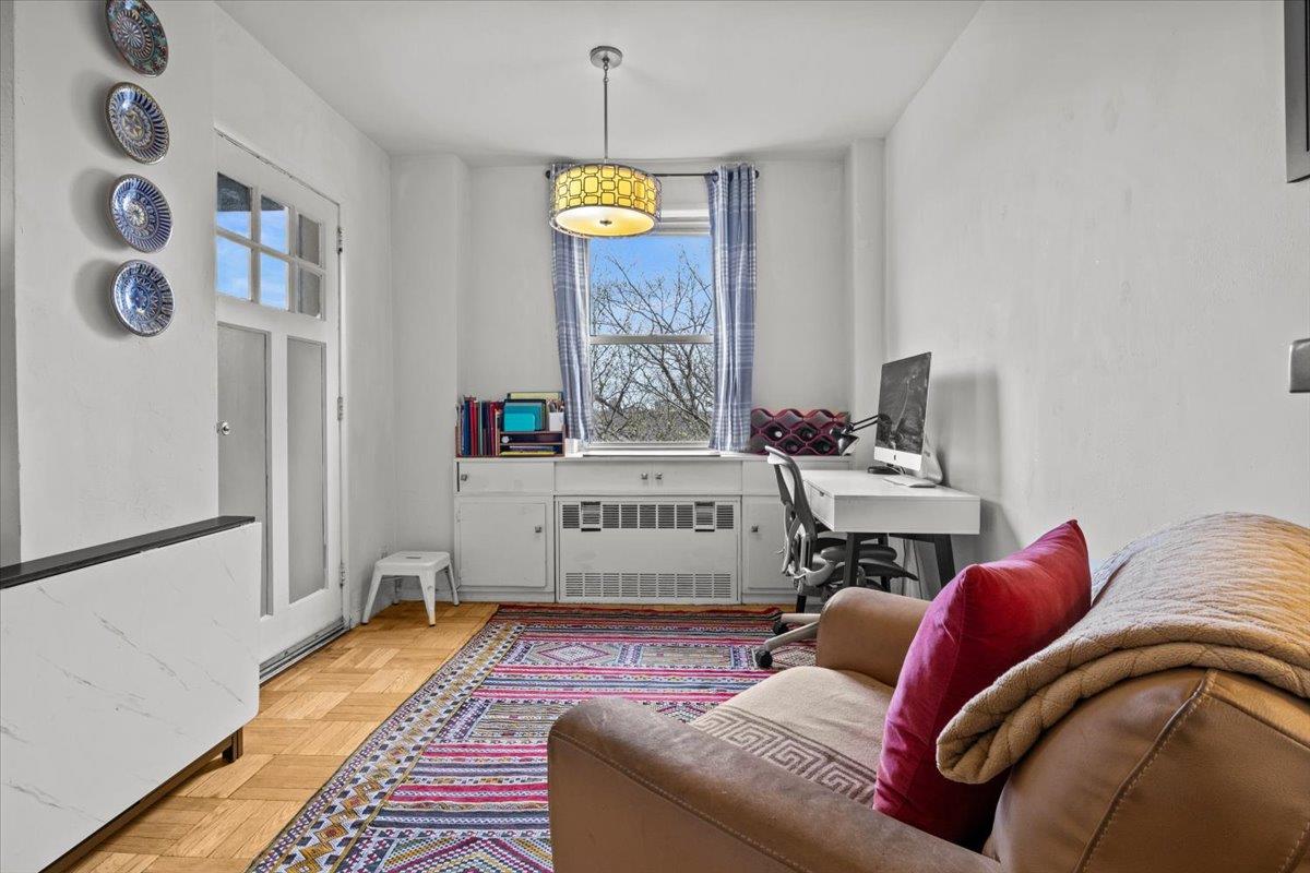 5550 Fieldston Road, Unit 7C Bronx, NY 10471 - Photo 11 of 26 a living room with furniture and a chandelier