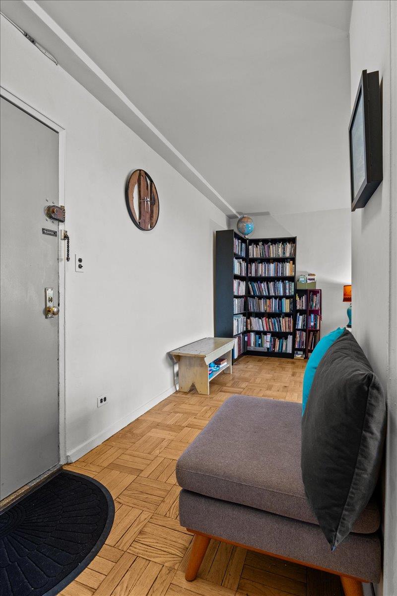 5550 Fieldston Road, Unit 7C Bronx, NY 10471 - Photo 16 of 26 a bedroom with a bed and a book shelf