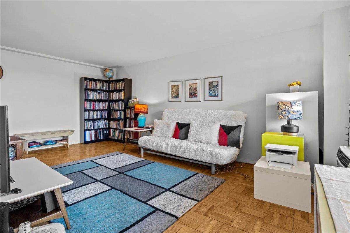 5550 Fieldston Road, Unit 7C Bronx, NY 10471 - Photo 6 of 26 a living room with furniture and book shelf