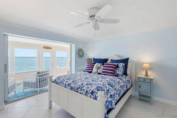 a bedroom with a large bed and a chandelier