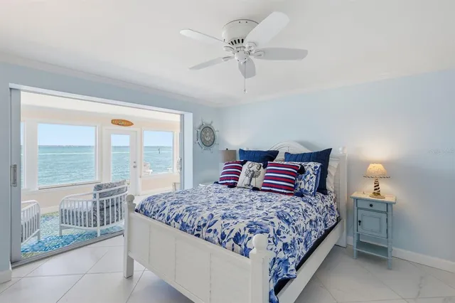 a bedroom with a large bed and a chandelier