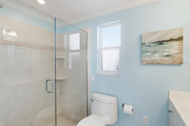 a bathroom with a toilet and a shower