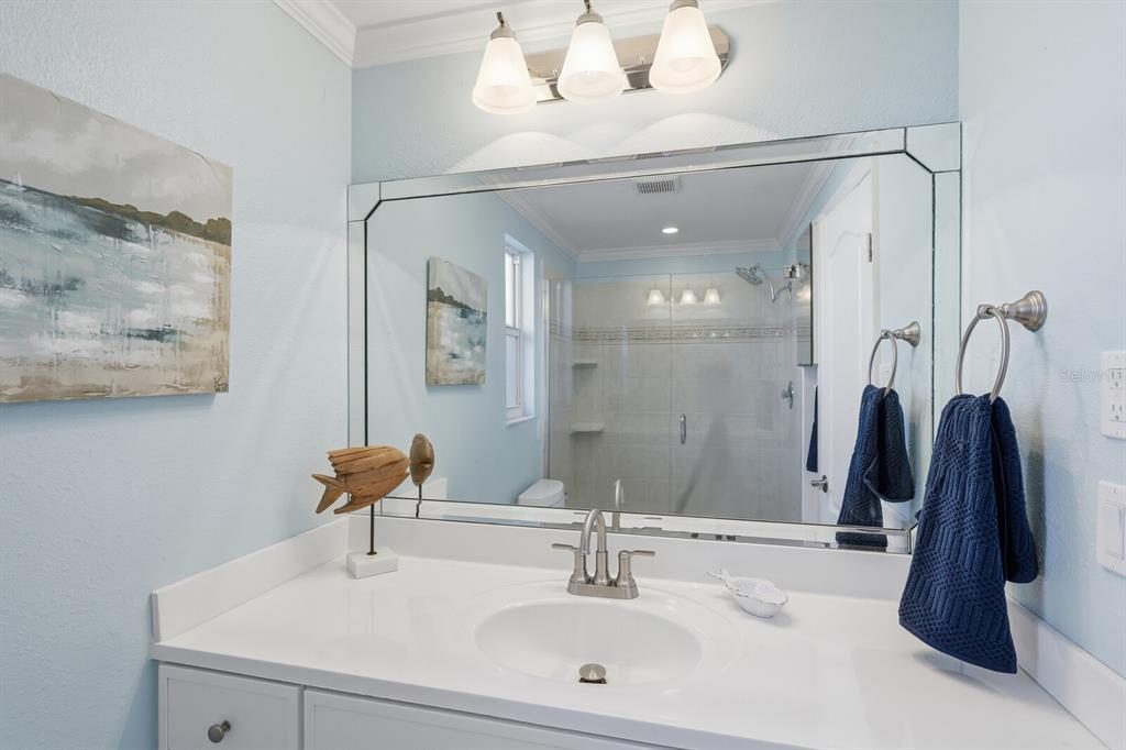 957 Spanish Drive North Longboat Key, FL 34228 - Photo 20 of 37 a bathroom with a sink and a mirror