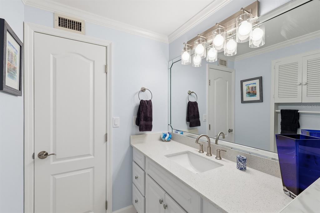 957 Spanish Drive North Longboat Key, FL 34228 - Photo 25 of 37 a bathroom with a double vanity sink and a mirror