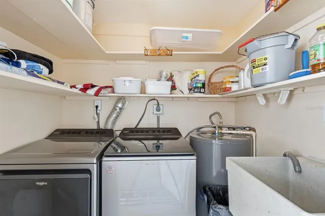 a utility room with sink dryer and washer