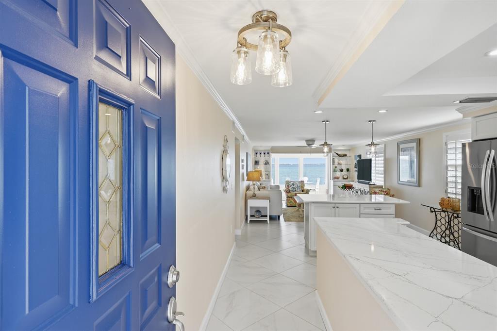 957 Spanish Drive North Longboat Key, FL 34228 - Photo 6 of 37 a view of a dining room with furniture a chandelier and wooden floor