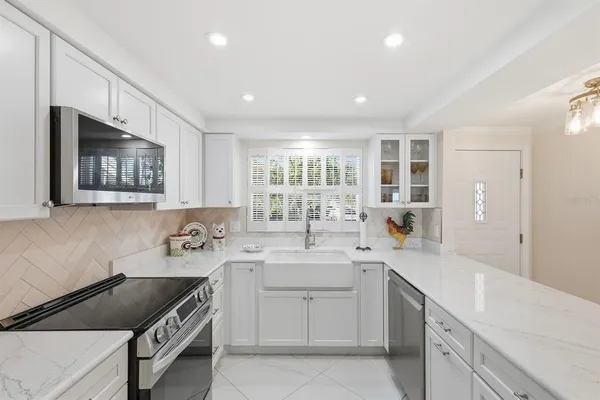 a kitchen with a sink stove and microwave