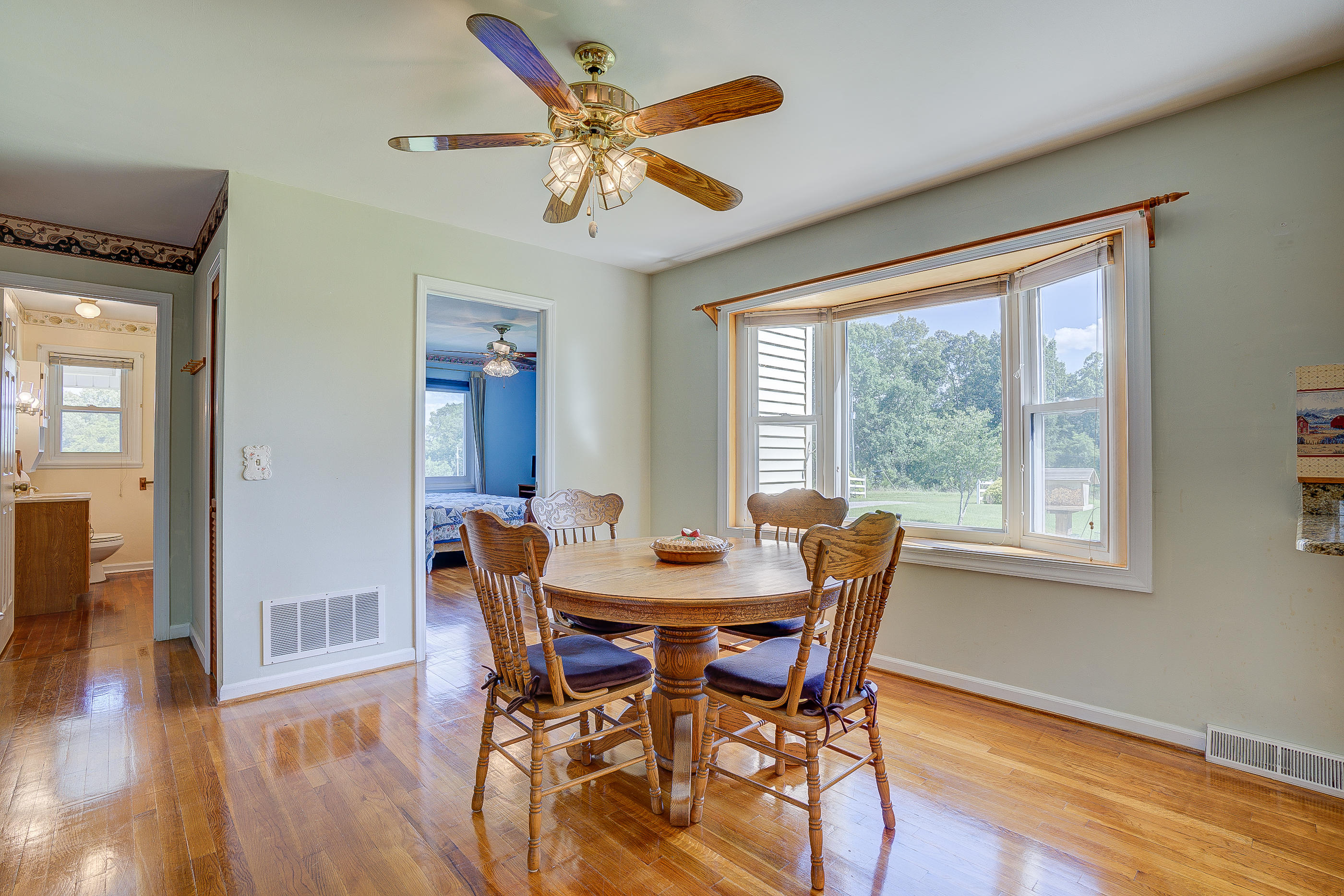 1311 Rock Spring Road Goodview, VA 24095 - Photo 17 of 54 a dining room with furniture window wooden floor
