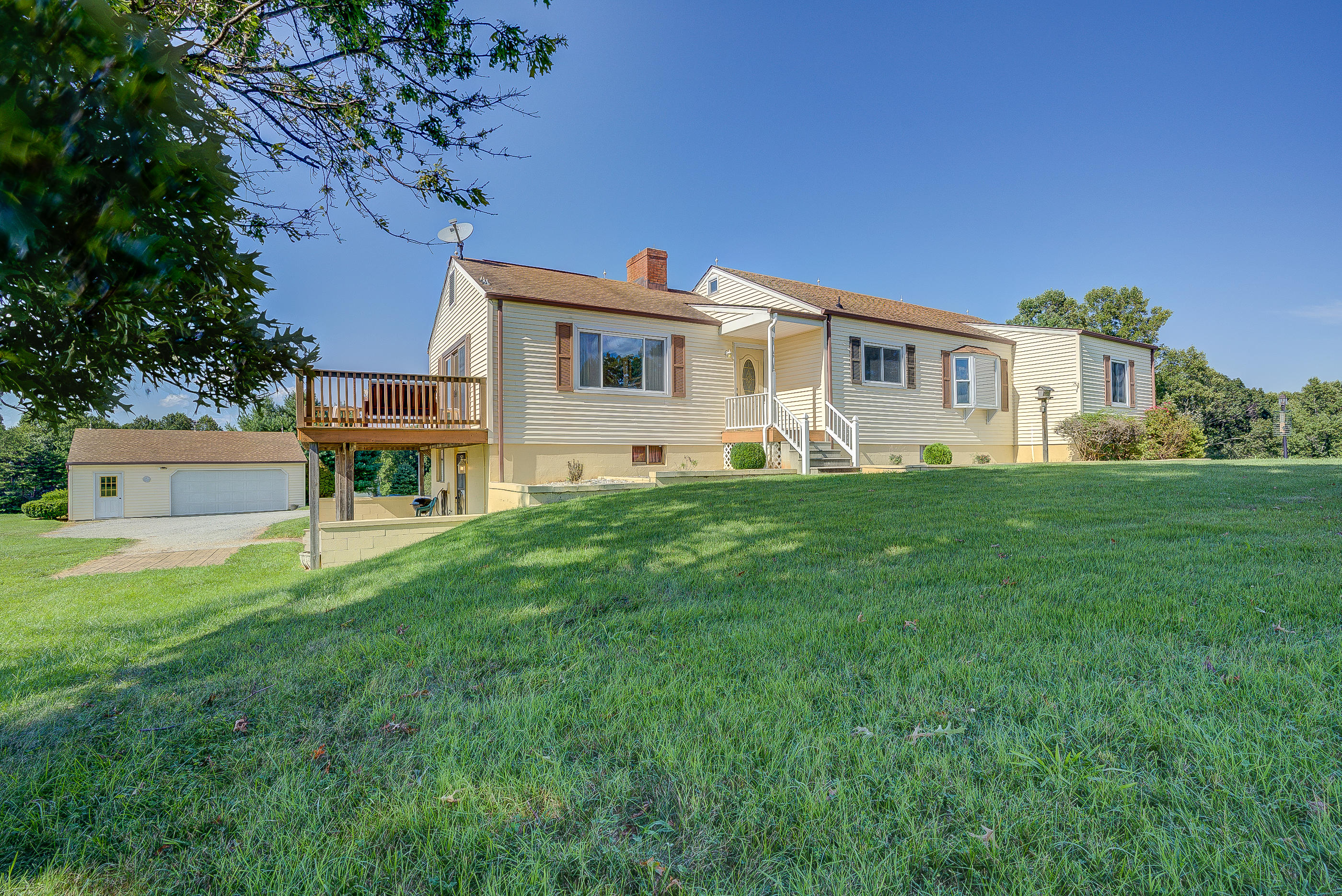 1311 Rock Spring Road Goodview, VA 24095 - Photo 29 of 54 a front view of a house with a yard and trees