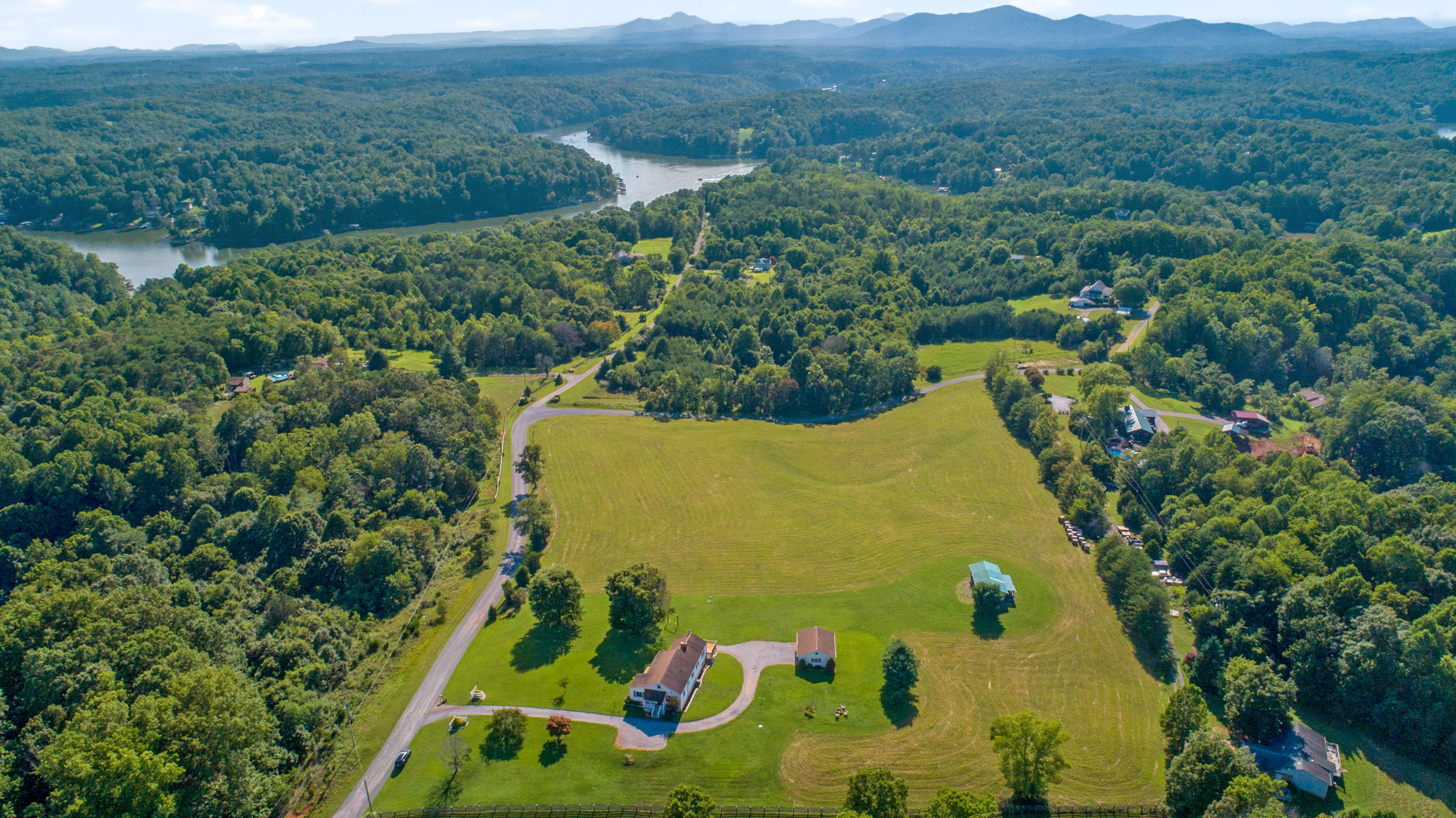 1311 Rock Spring Road Goodview, VA 24095 - Photo 47 of 54 an aerial view of a residential houses covered in trees