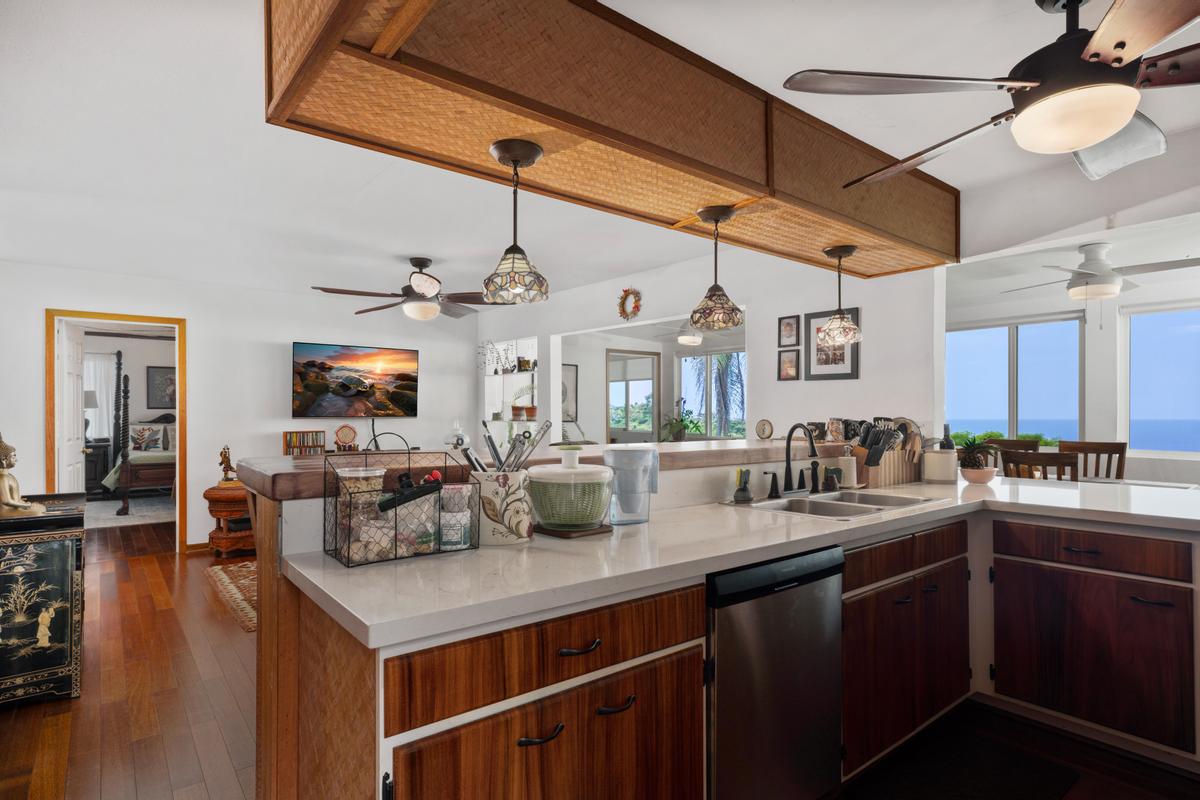 85-4563 Hawaii Belt Road Captain Cook, HI 96704 - Photo 7 of 30 a kitchen with a sink cabinets and wooden floor