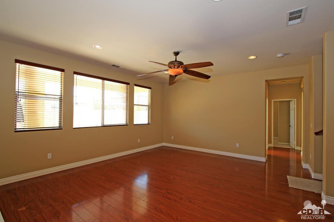 83271 Wagon Road Indio, CA 92203 - Photo 6 of 40 a view of empty room with wooden floor and fan