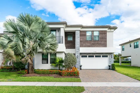 a front view of a house with a yard and a garage
