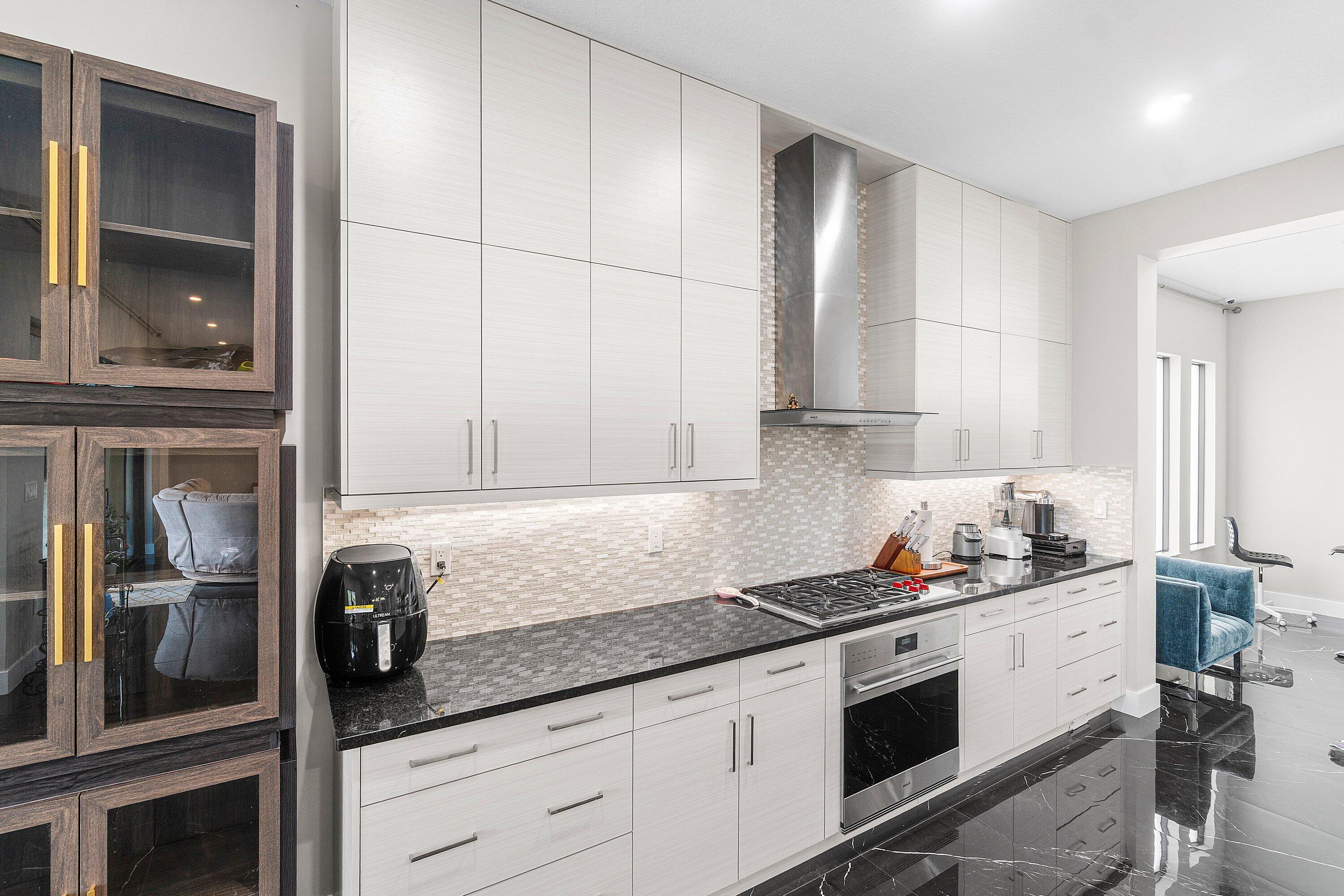 17238 Teton River Road Boca Raton, FL 33496 - Photo 12 of 67 a kitchen with granite countertop stainless steel appliances a sink stove and cabinets