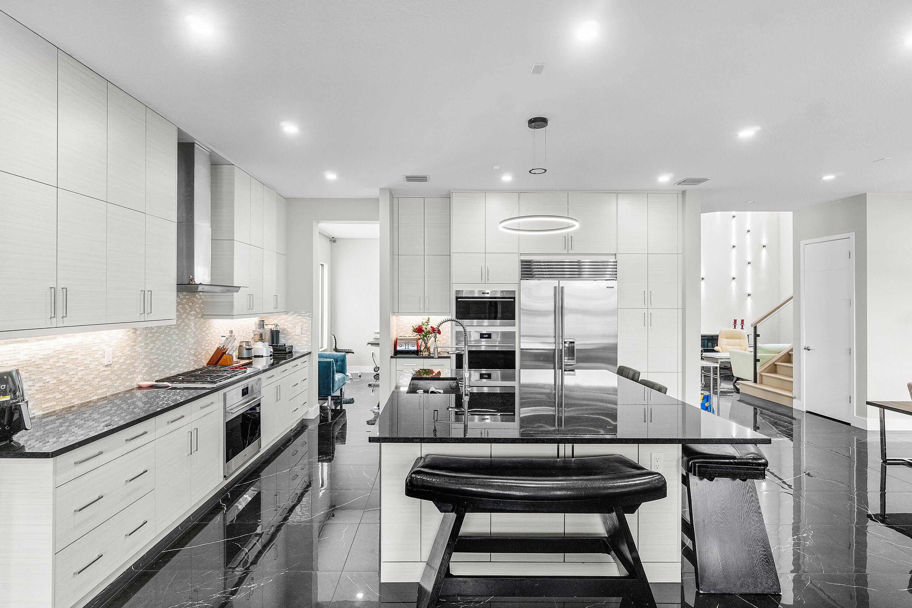 17238 Teton River Road Boca Raton, FL 33496 - Photo 13 of 67 a kitchen with counter top space cabinets and stainless steel appliances