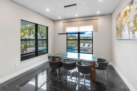 a living room with furniture a flat screen tv and a large window