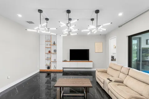 a bedroom with furniture and a large window