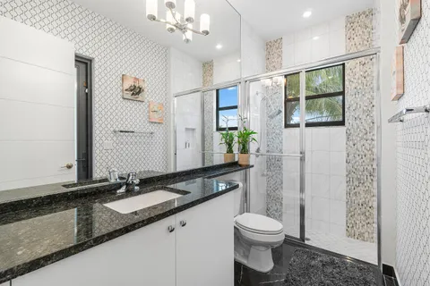 a spacious bedroom with a bed and a chandelier