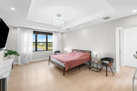 a bedroom with a bed and a flat screen tv