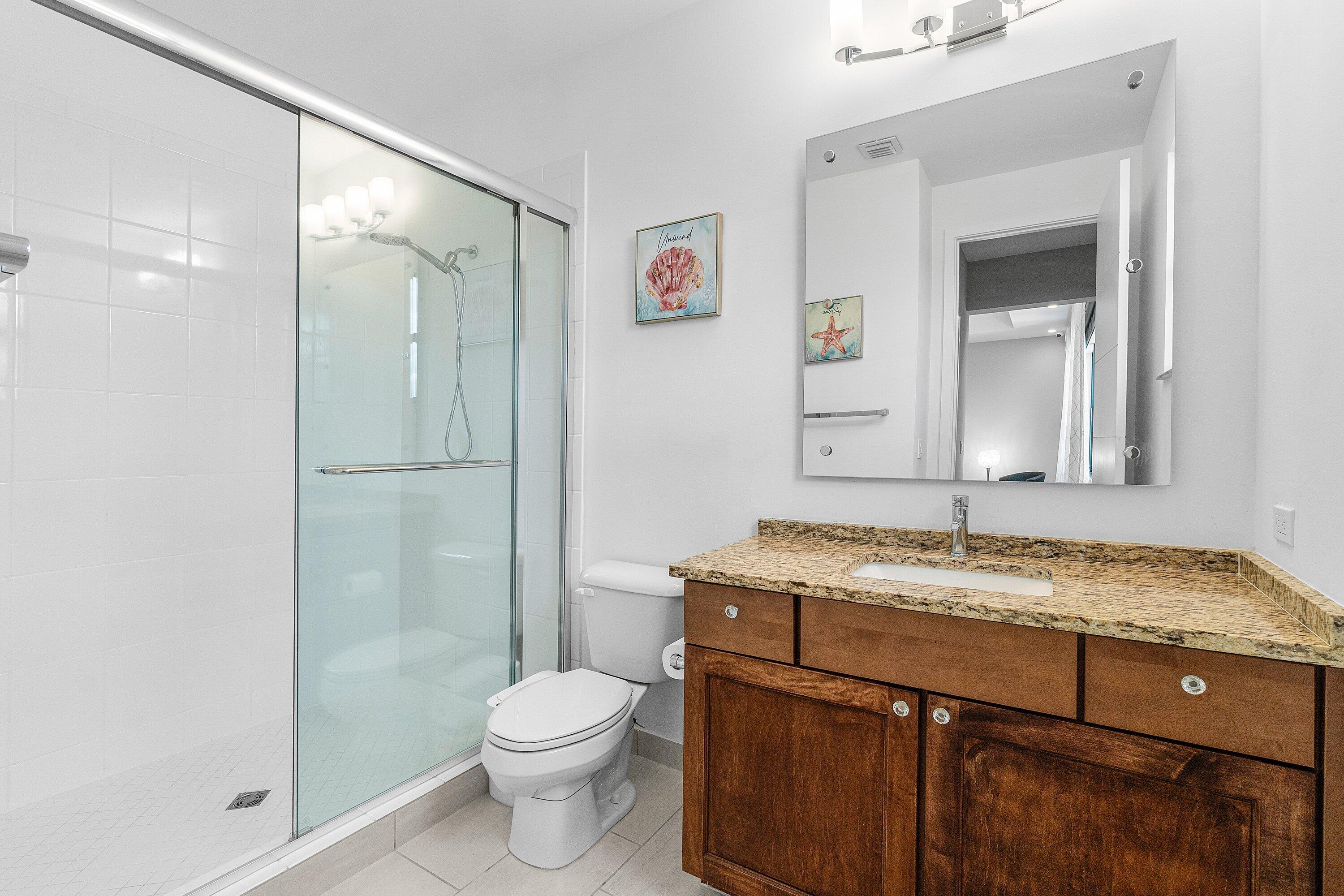 17238 Teton River Road Boca Raton, FL 33496 - Photo 30 of 67 a bathroom with a granite countertop sink toilet and shower