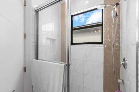 a bathroom with a granite countertop sink a toilet and shower