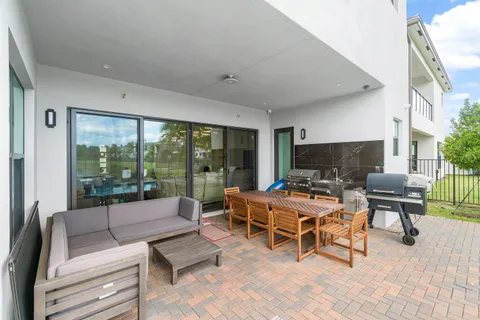 a view of a swimming pool with outdoor seating