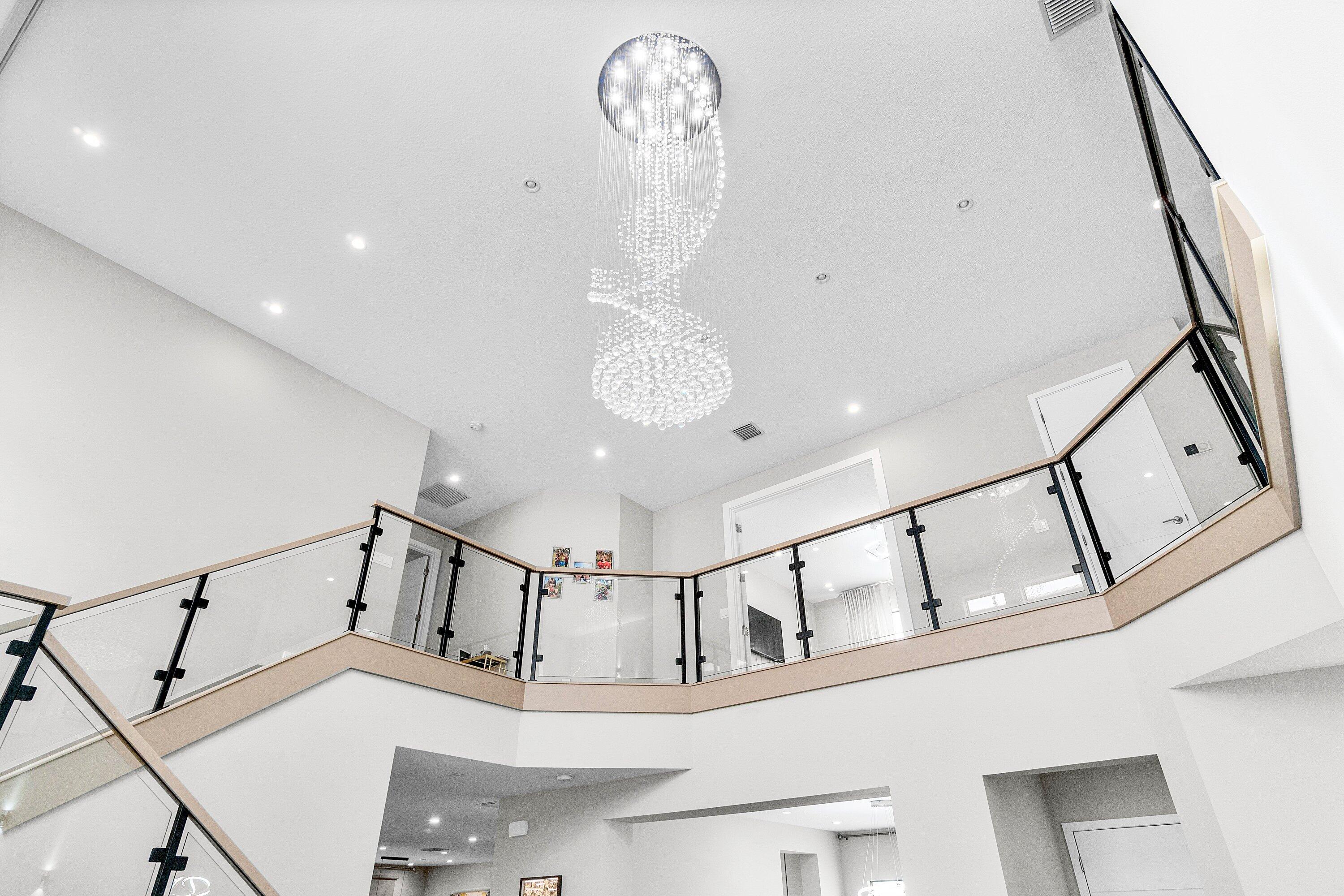 17238 Teton River Road Boca Raton, FL 33496 - Photo 8 of 67 a view of staircase with white walls and a chandelier
