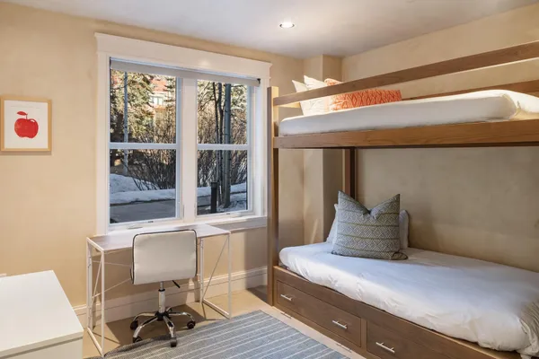 a bedroom with a bed and a painting on the wall